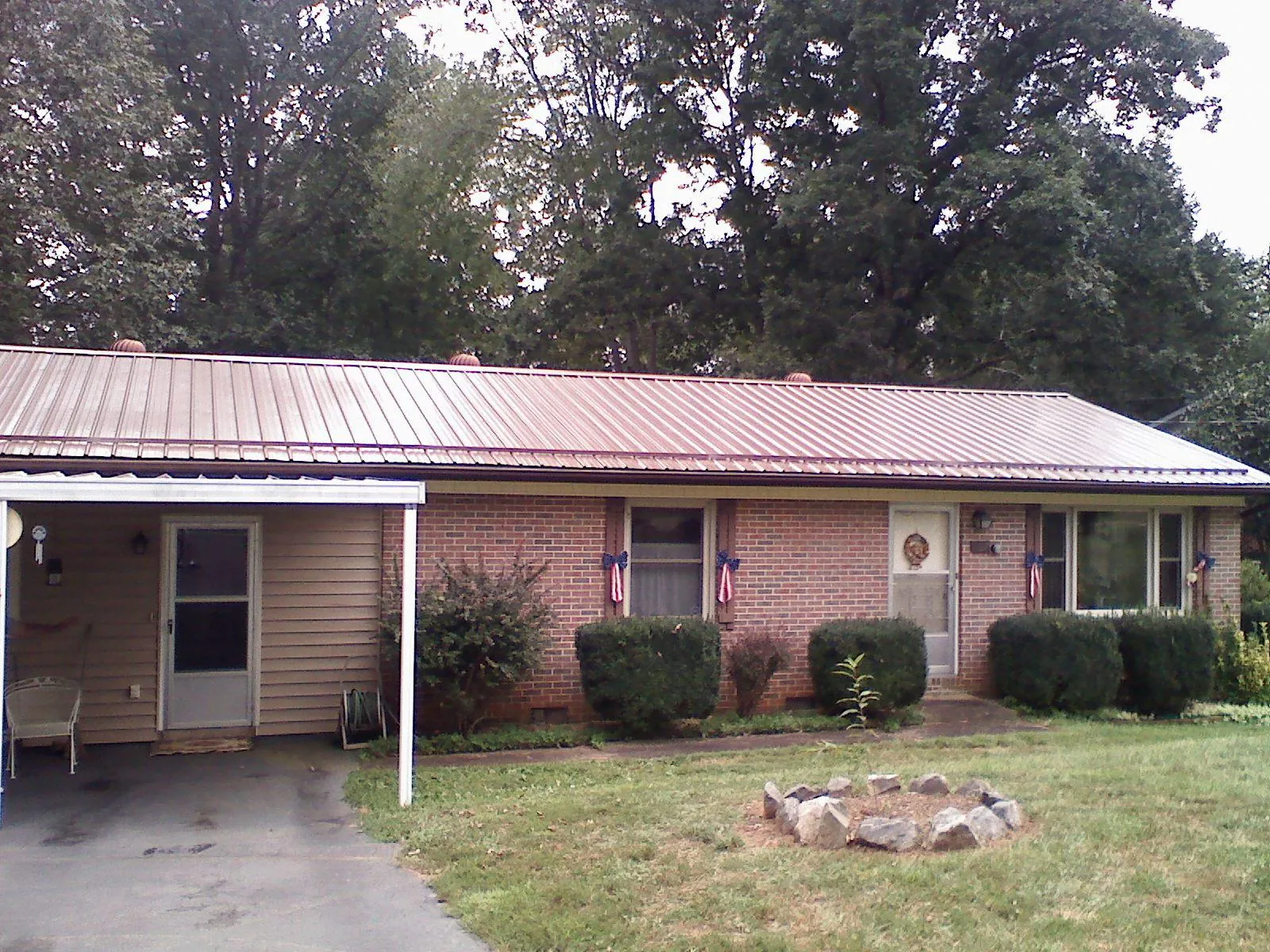 Bronze metal roof and carport on a brick ranch home — Roof Repair work by our crew in Winnetka