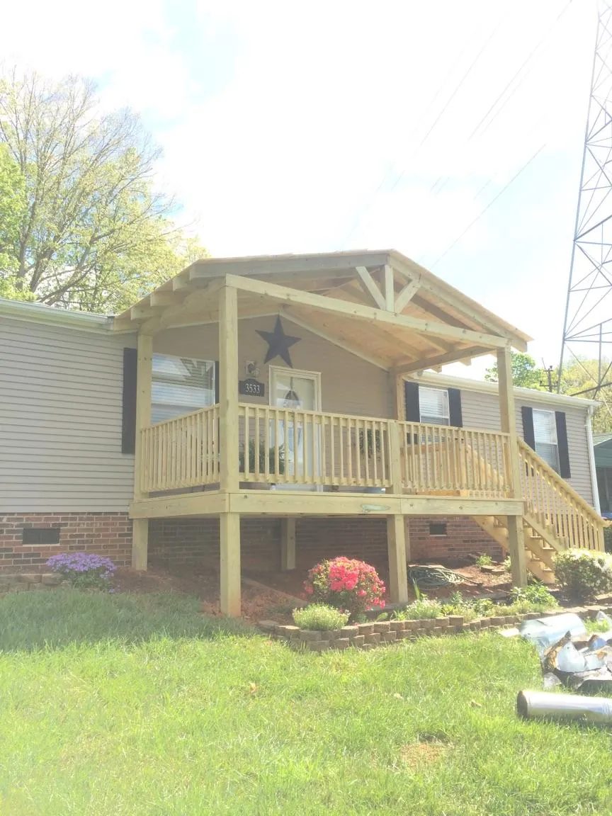 New gabled porch roof and deck railing added to a ranch home in Winnetka